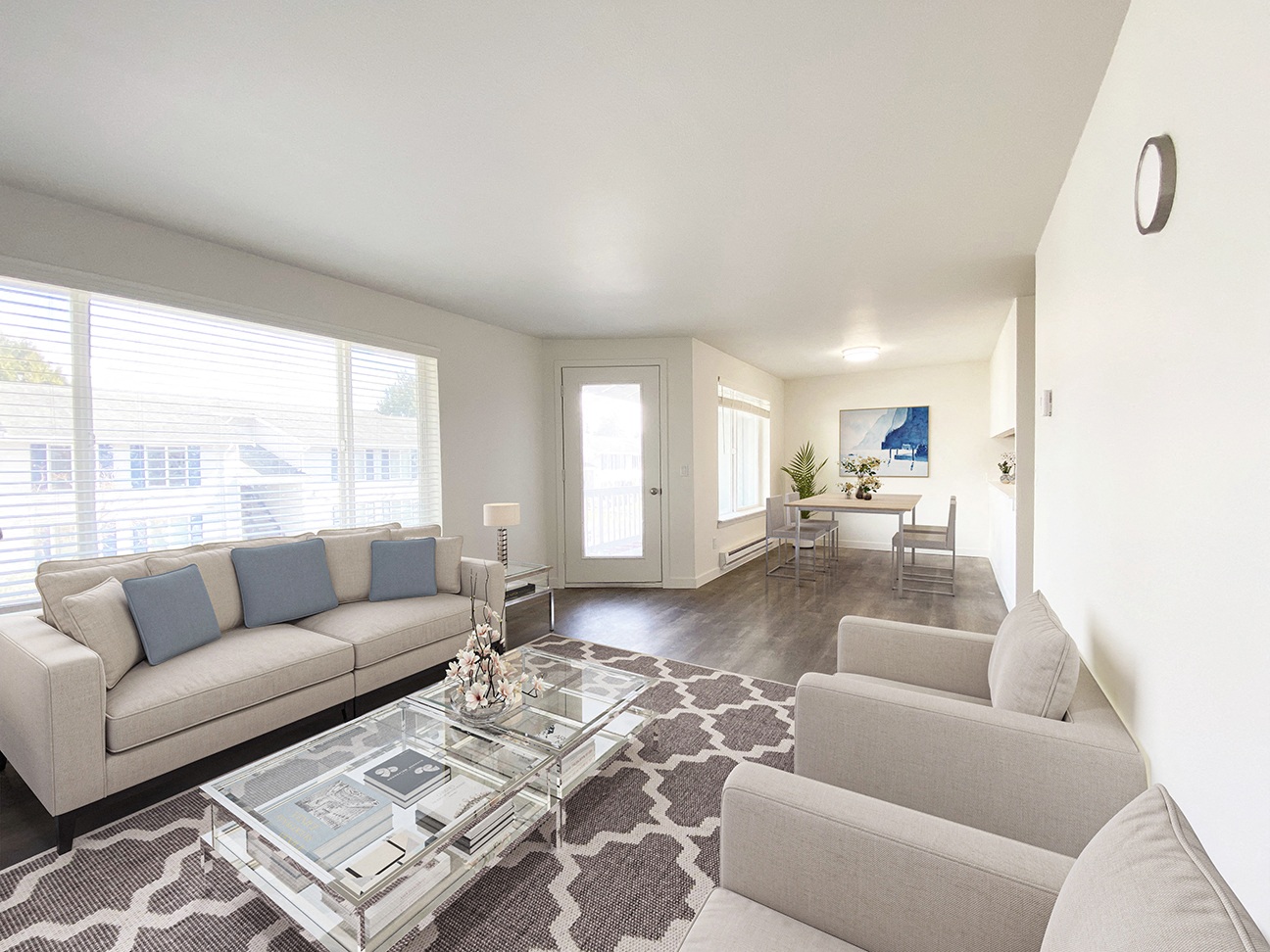 a living room with two couches and a glass coffee table